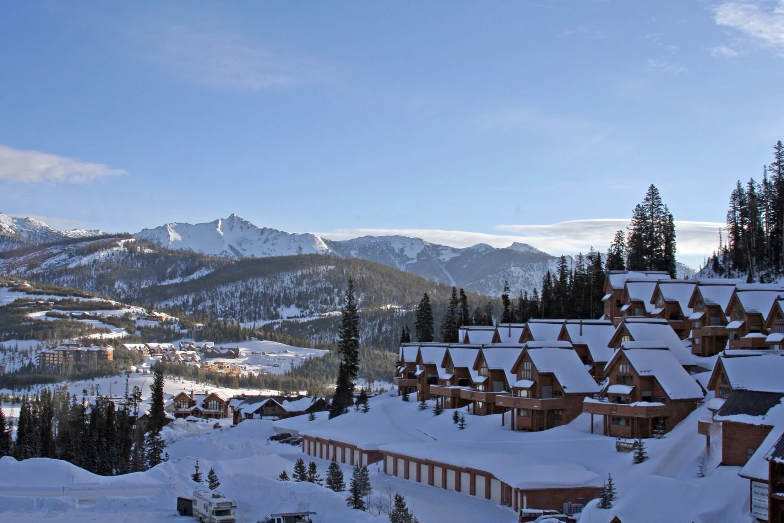 Snow-covered resort lodges and mountain slopes at Big Sky, Montana.