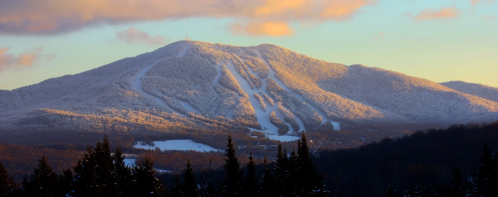 Evening light on the snow-covered ski runs of Burke Mountain, Vermont.