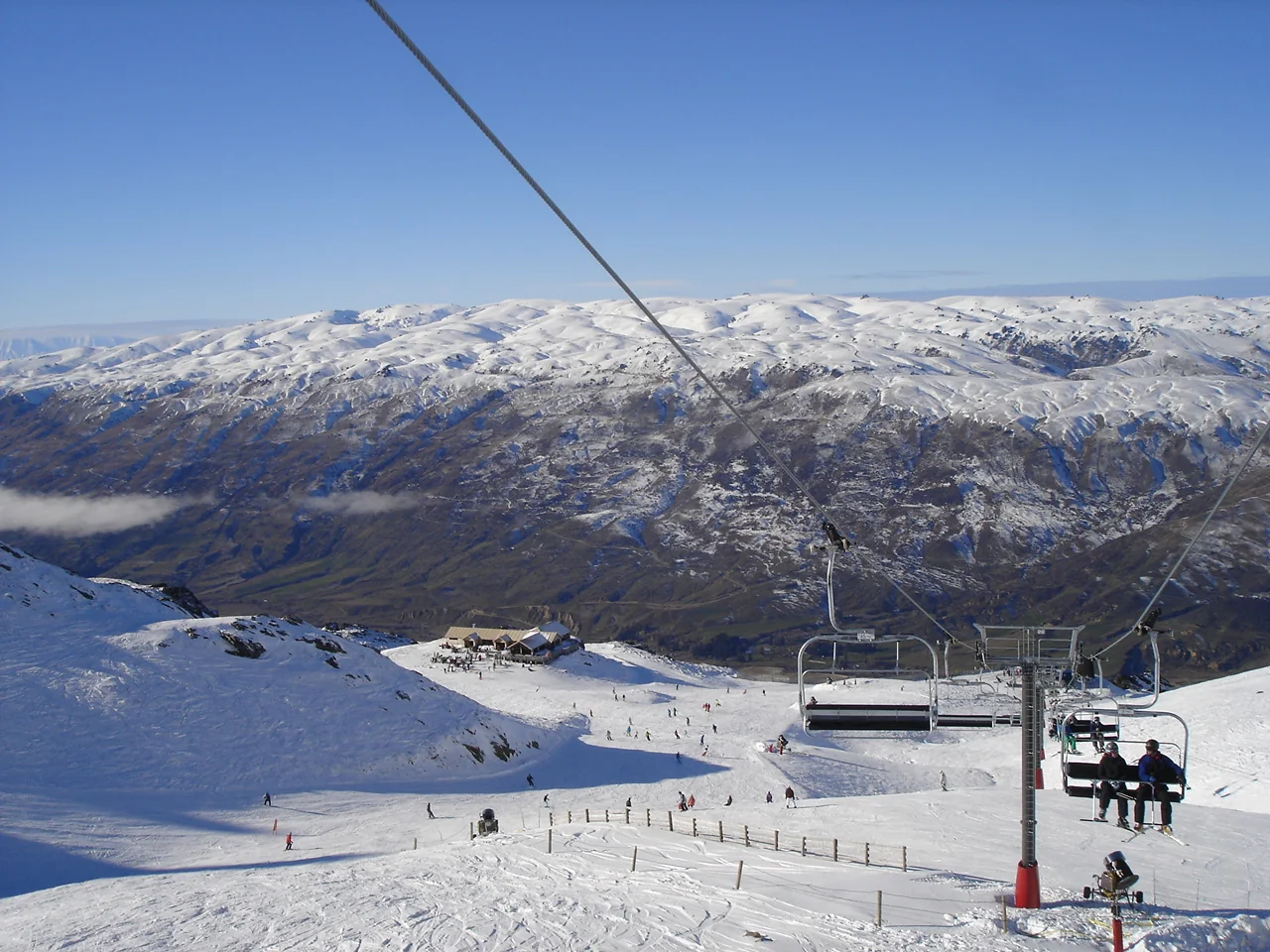 Chairlift, ski slopes and a mountain valley at Cardrona Ski Area, New Zealand