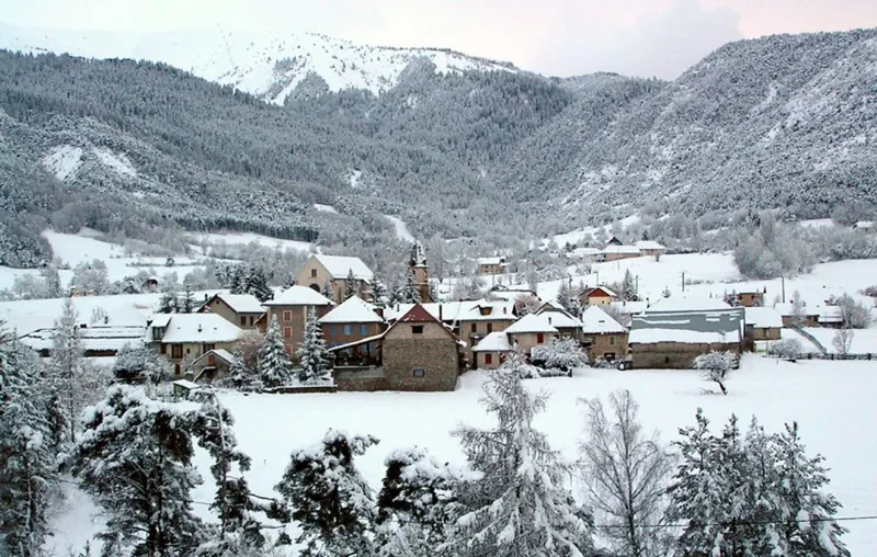 Snow-covered houses and hills around Selonnet village.