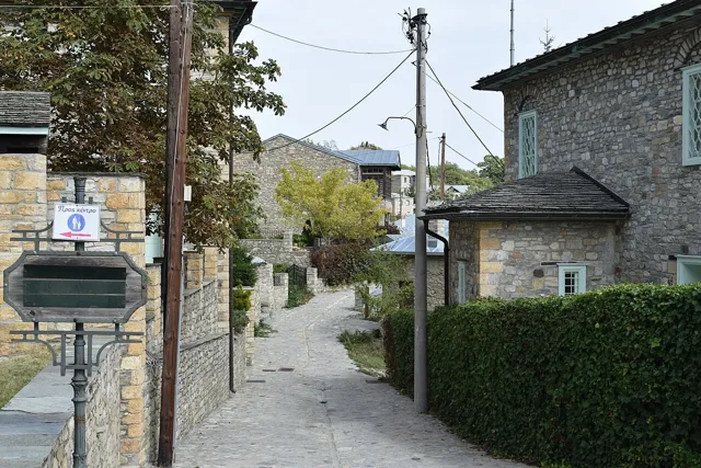 A lane between stone buildings in Nymfaio
