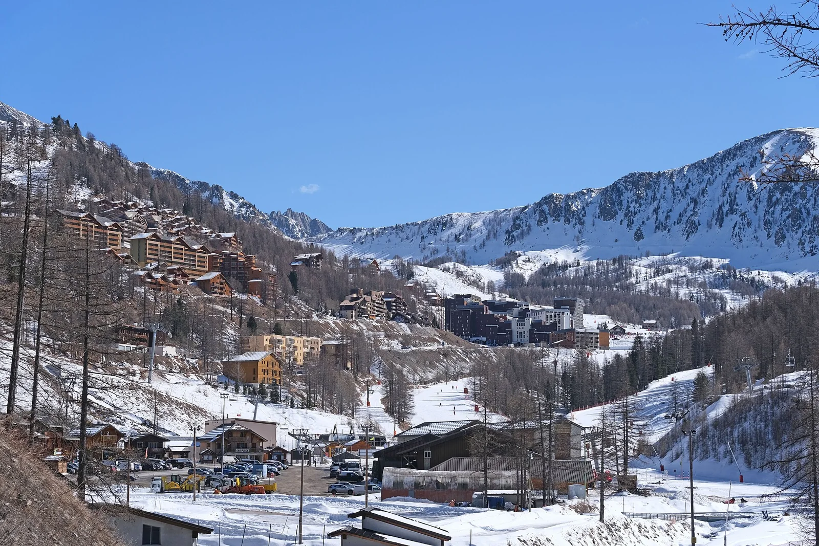 Isola 2000 buildings in a snowy valley with runs on the surrounding slopes.