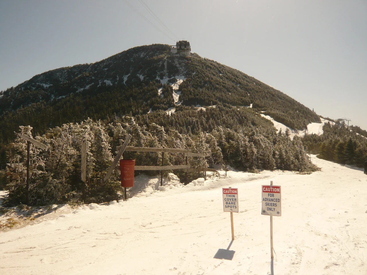 The summit of Jay Peak rises above a snowy ski run in Vermont.