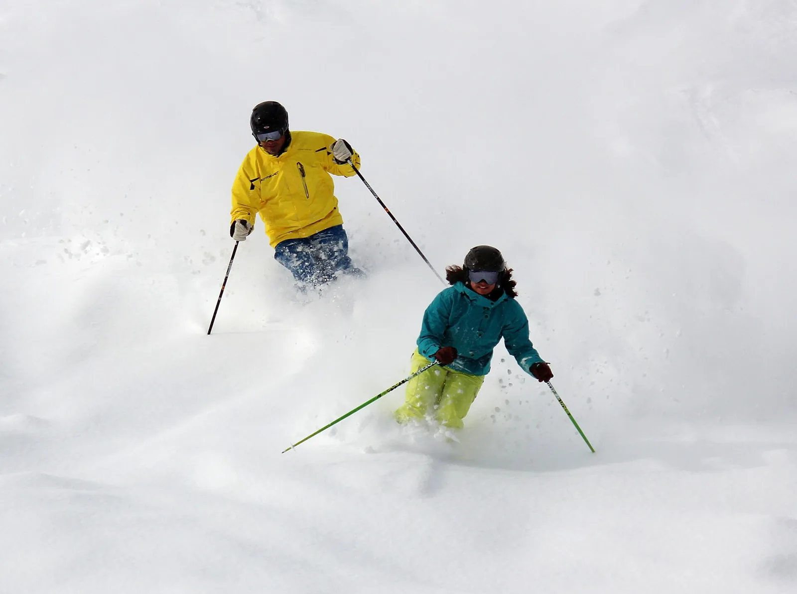 Two skiers descending deep snow at Lookout Pass on the Idaho–Montana border.