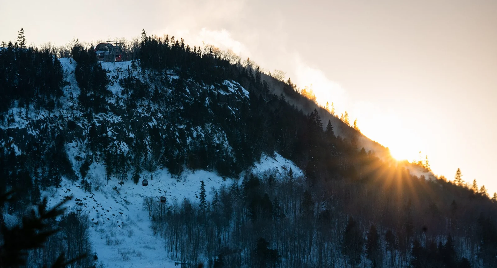 Sunset behind a snowy ski hill at Lutsen Mountains, Minnesota.