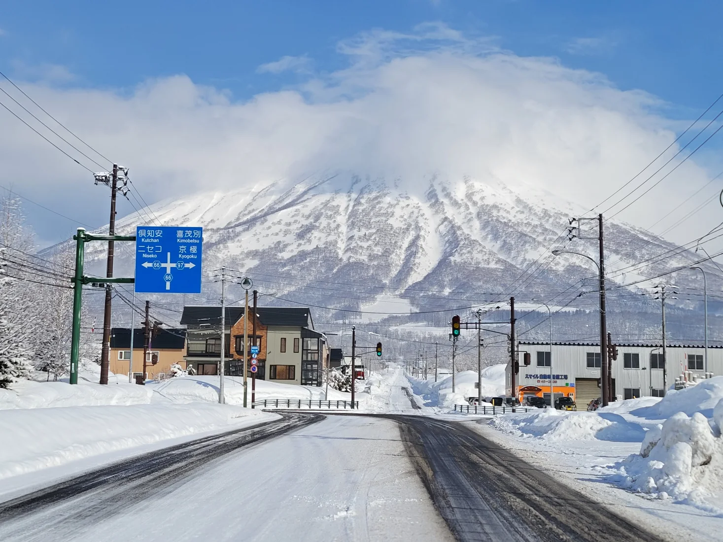 Snow-covered Mount Yotei and a road junction in Makkari, near Niseko, Hokkaido, Japan