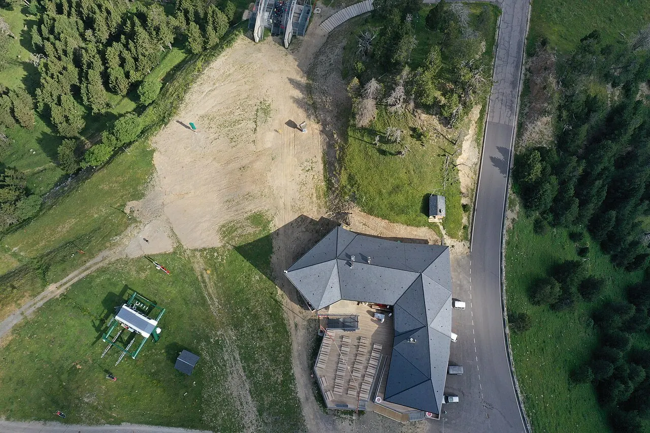 Drone view of Telefèric Arinsal-Pal and Restaurant Coll de la Botella in La Massana, Andorra. Yellow disc golf baskets are visible in picture.