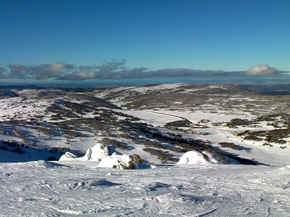View from near summit of Mount Perisher towards Perisher village and car park. New South Wales, Australia. July 2011.