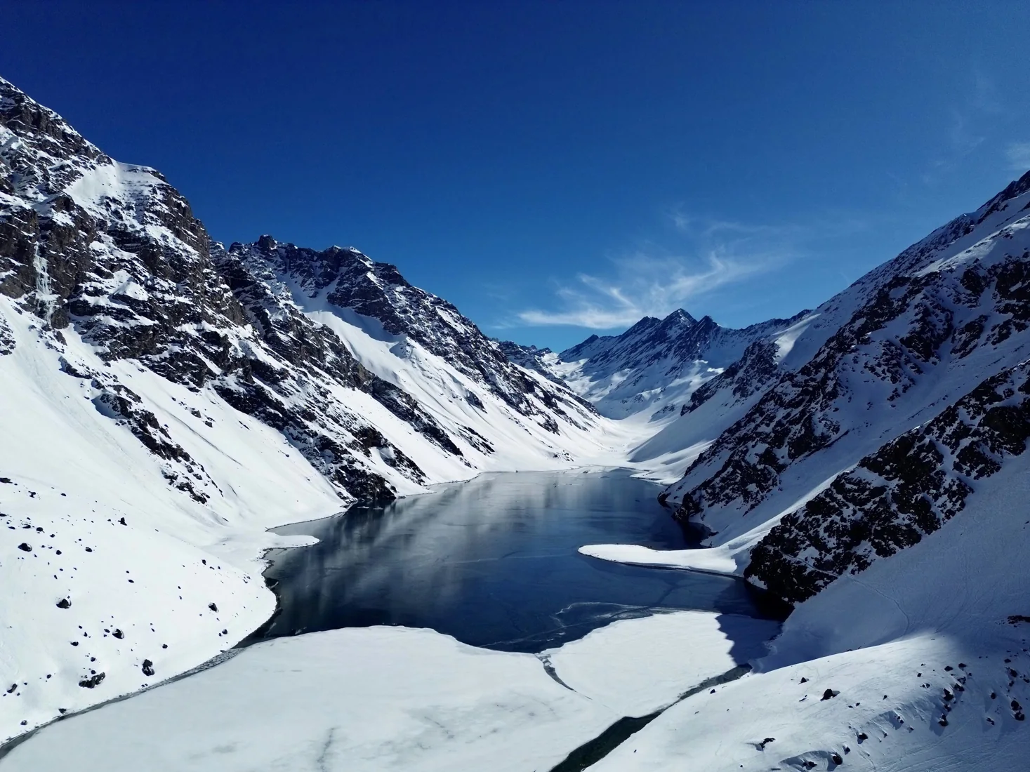 Laguna del Inca surrounded by snow-covered Andes mountains, Portillo, Chile