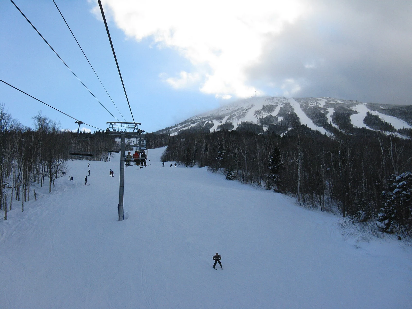 A chairlift and snow-covered ski runs at Sugarloaf in Maine.