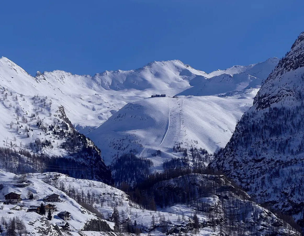 Sight, in a winter afternoon from the Tignes dam, towards Val-d'Isère ski resort and Solaise gondola lift, beyond La Daille gorge, in Savoie, France.