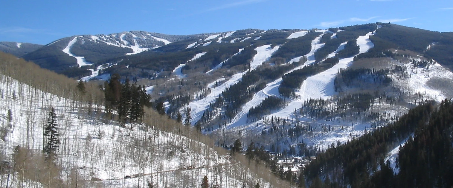 Snow-covered front-side ski runs at Vail, Colorado, viewed across the valley.